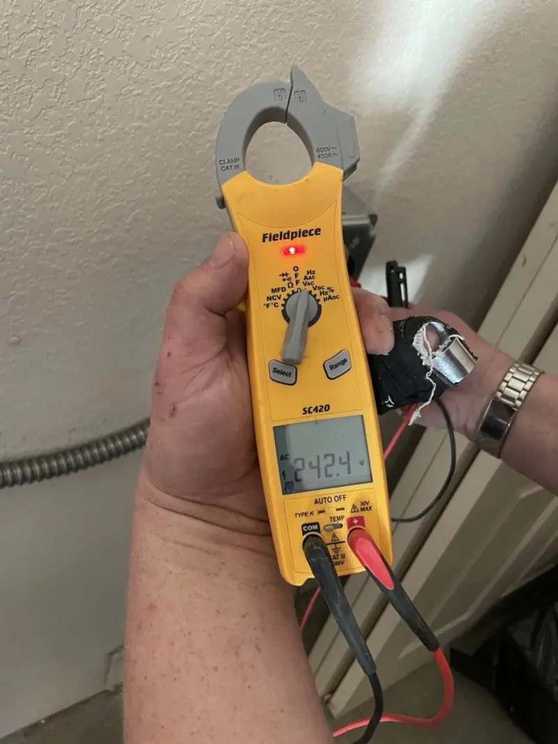Voltage testing with clamp meter during Ceiling Fan Installation in Addis